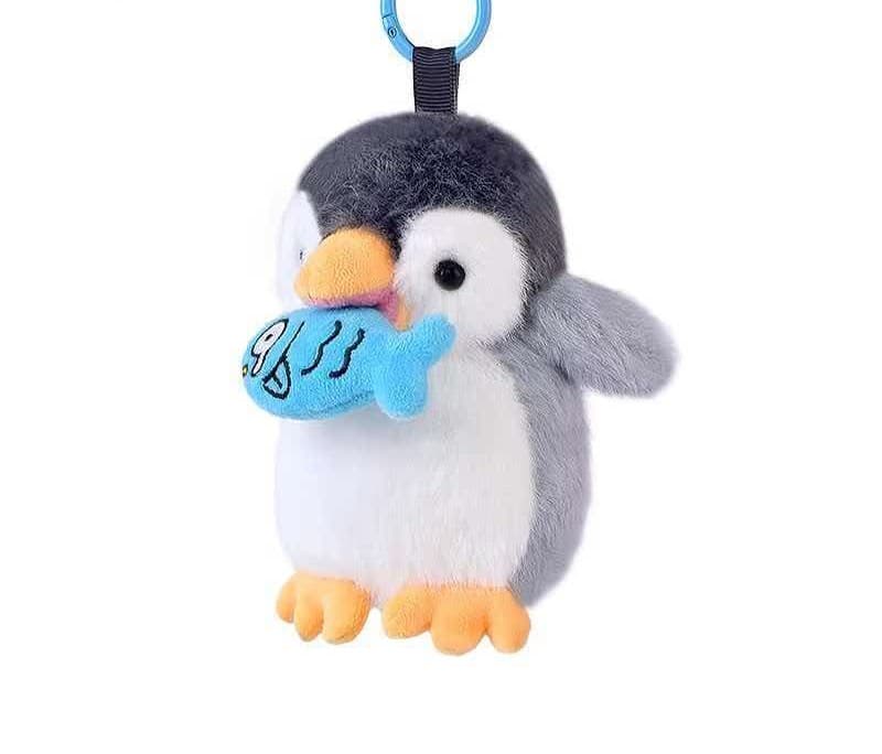Penguin mascot plush keychain showing a compact merchandise direction